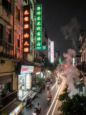 Vertical neon signs on narrow building