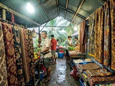 Humid tropical market light in Suva, Fiji, Masi cloth patterns next to Indian pr