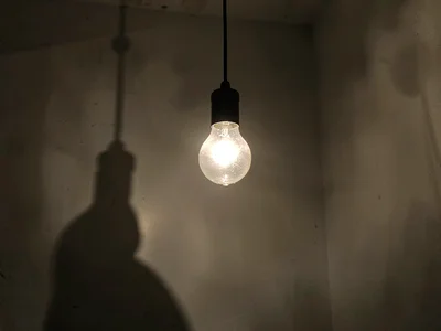Single bare bulb illuminating room