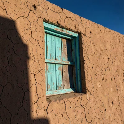 Turquoise Window in Adobe Wall