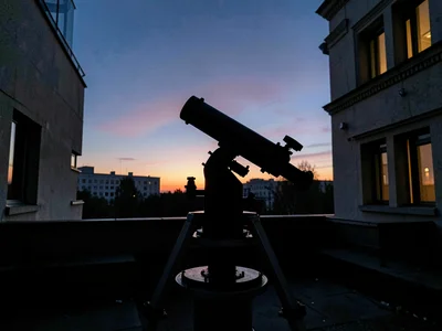 Telescope tracking mount silhouette at dusk