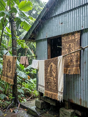 Open-air fale life in Samoa after rain, Tapa cloth patterns drying in the humid 