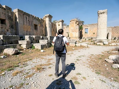 A single tourist at ancient ruins during the noon hour when everyone else has fl
