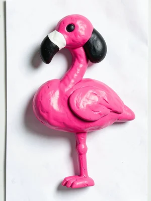Graceful chunky clay flamingo in primary pink with stubby black squat beak and o