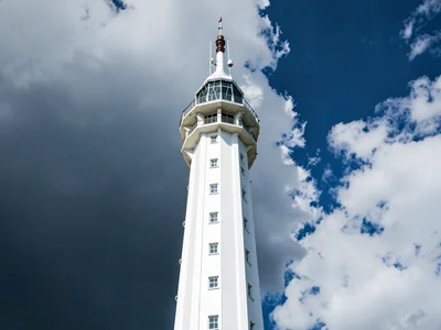 Cloud base dark against white tower