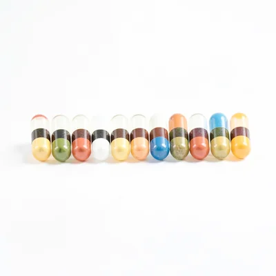 Clean studio macro of a perfectly aligned row of capsules, soft top light