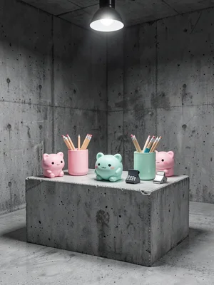Kawaii desk accessories arranged on raw concrete block, pencil cups and staplers