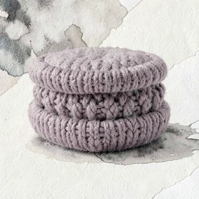 Sandwich-style soft-plum knit macaron with a bouclé filling between two pillowy