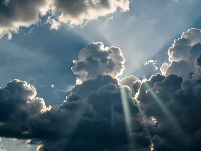 Crepuscular rays revealing atmospheric depth through cloud gaps