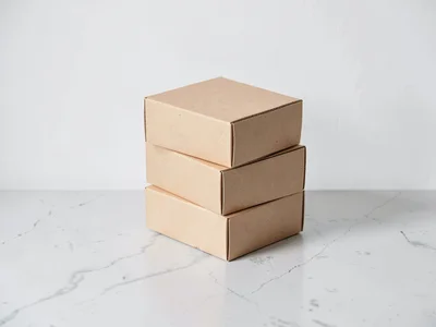 Stacked kraft boxes angled on pale concrete