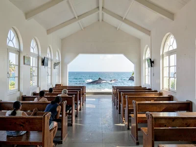 Sunday stillness in Nuku'alofa, Tonga, Simple white church interior with wooden 