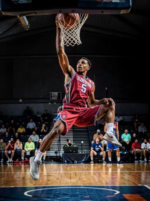 Basketball player dunking from below