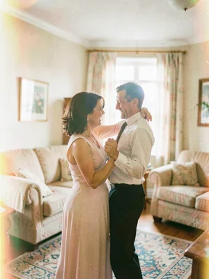 Couple slow dancing in living room