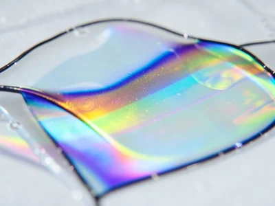 Extreme closeup of soap film thickness transition zone, sharp boundary between b