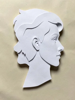 Paper craft portrait in profile, layered paper creating depth, shadows between l