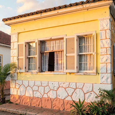 Chattel house colors in Barbados afternoon light, Yellow chattel house windows, 