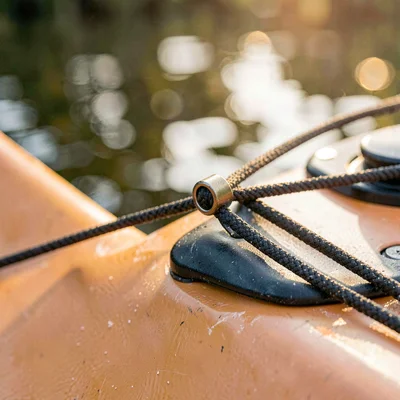 Macro of a kayak deck rigging with bungee cord and a small clip