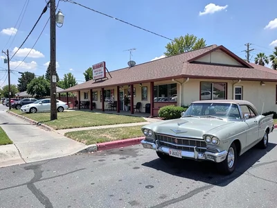 Roadside motel with vintage car parked