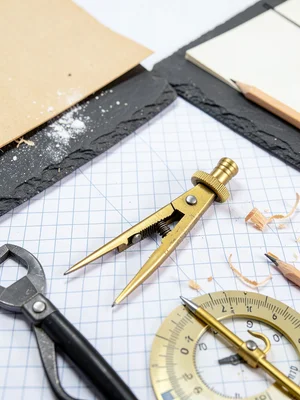 Drawing Compass Brass Open on Graph Paper
