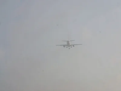 Aircraft visible above smog