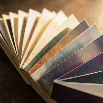 Texture study of fanned cards with edge gradient catching low warm light