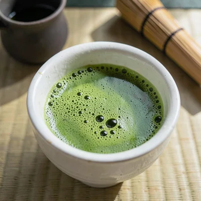 Shino chawan with vivid matcha foam close-up