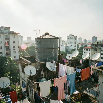 Documentary photograph of megacity life, dense urban scene, A rooftop water tank