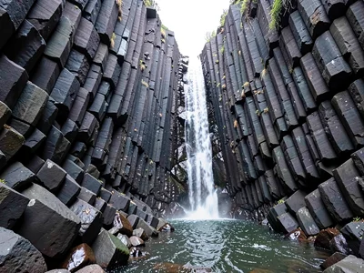 Waterfall framed by basalt column walls