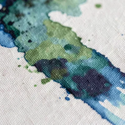 Surface macro of an inkjet-printed canvas with pigment soaking into the weave