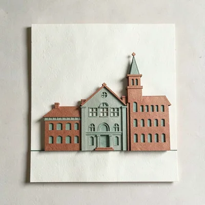 Papercraft composition of a layered paper-cut mill building silhouette across cr