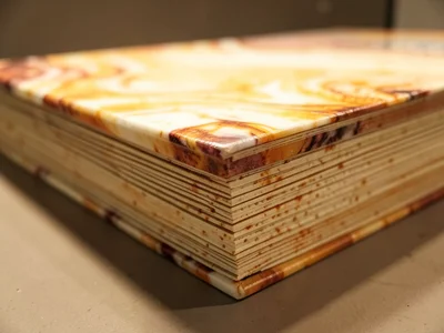 Marbled book edge, swirled pattern applied to closed book block creating abstrac