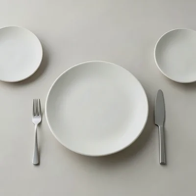 Restaurant table setting in Bauhaus arrangement, plates as circles, cutlery as l