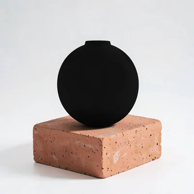Color-block shot of a hitch ball silhouette on a terracotta block, no readable t
