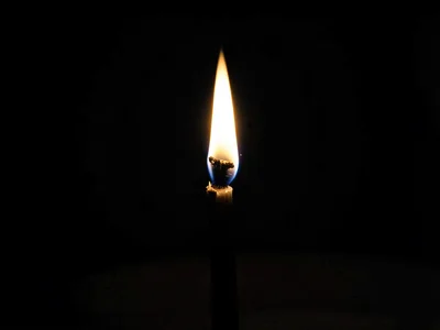 Single match flame in darkness