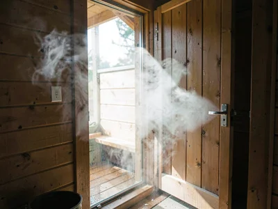 Sauna door opening, steam escaping, the cloud of moisture released