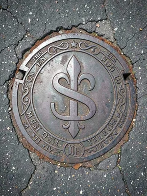 Sewage Cover with Fleur-de-Lis and S Monogram