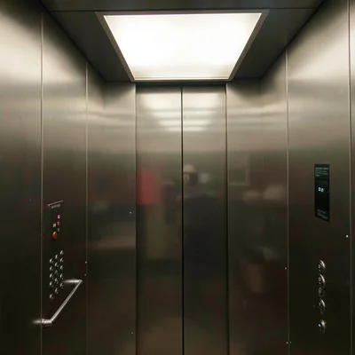 Mirror selfie position in a corporate elevator with stainless walls