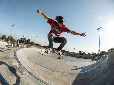 Skateboarder mid-trick with curved horizon