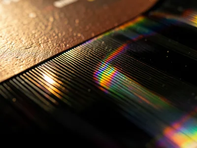 Record label edge where paper meets vinyl, transition from printed surface to gl