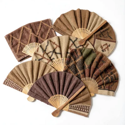 Warm tapa cloth browns and geometric pattern rhythm, A collection of woven fans 