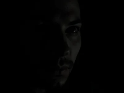 Face emerging from darkness partial