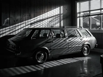 Station wagon in dramatic side light, wooden paneling reflecting sunset, vintage