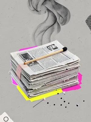 A photographic cutout of a single matchstick laid across a stack of folded newsp