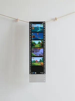 Film strip hanging to dry but frames contain pixelated video game scenes