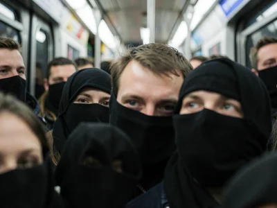 Sea of masked faces in subway car, compressed so features blur together, one per