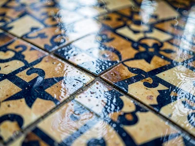 Tile pattern reflected in wet floor surface