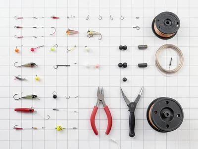 A fisherman's tackle: hooks graded by size, lures, bobbers, weights, pliers, lin