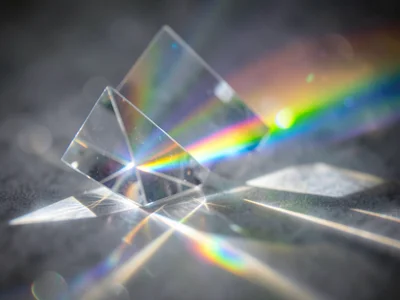 Prism spectrum projected onto fog, visible light beam fanning into color bands i