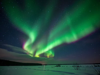 Aurora through thin cloud layer, green glow diffused and softened by cirrus, cre