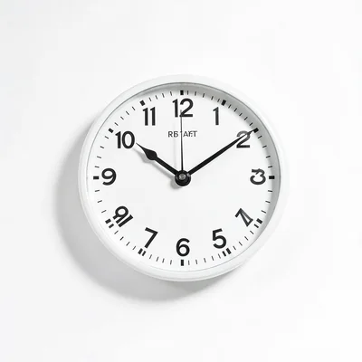 Clean white-background product photo of a wall clock, soft even studio shadow, p